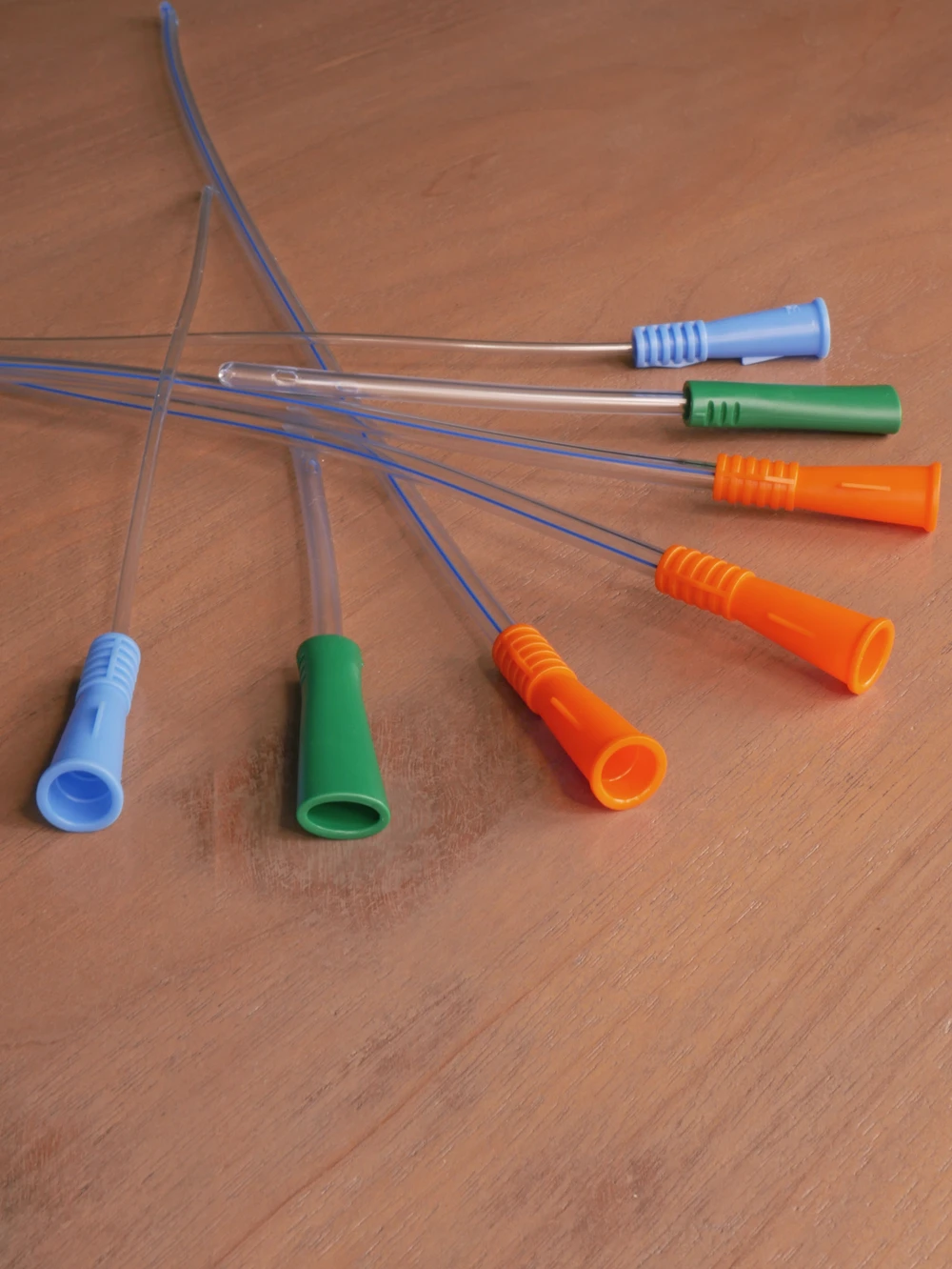 Picture close-up of intermittent catheters from RA Fischer layed out on a table.