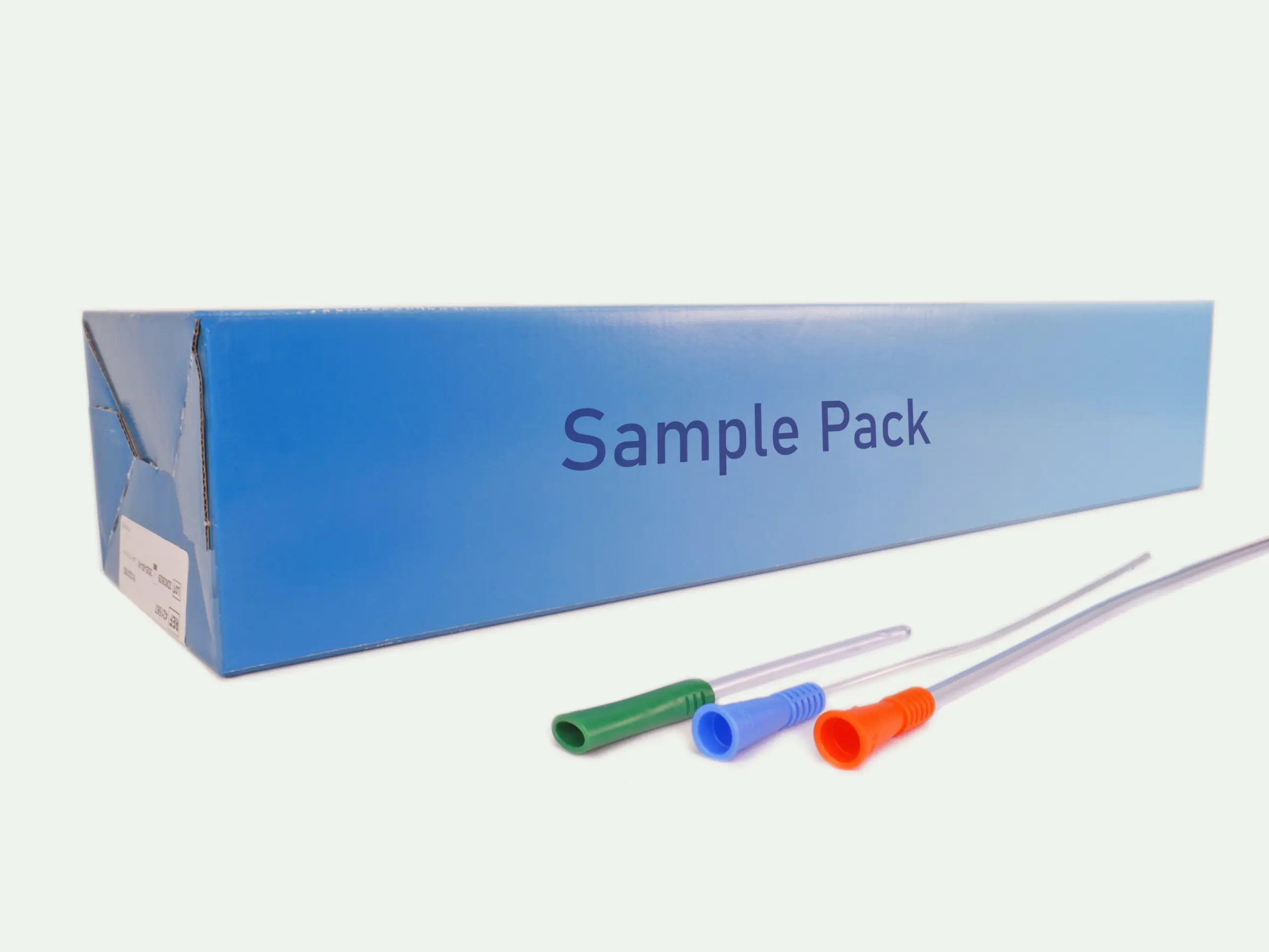 Picture of the box of 3-Day Free Sample Pack of catheters from RA Fischer. In front of the box are three of the catheters available, one long with an orange gripper, one medium length with a blue gripper, one short with a green gripper [ Personalized urology care ]