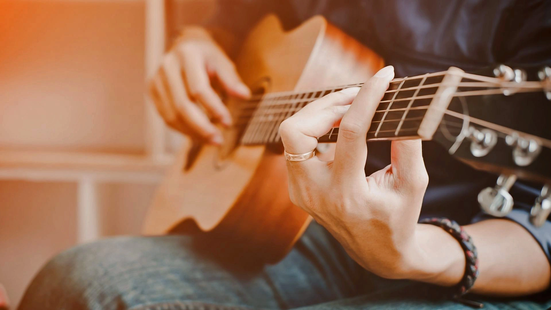 Close-up picture of a patient playing a guitar.