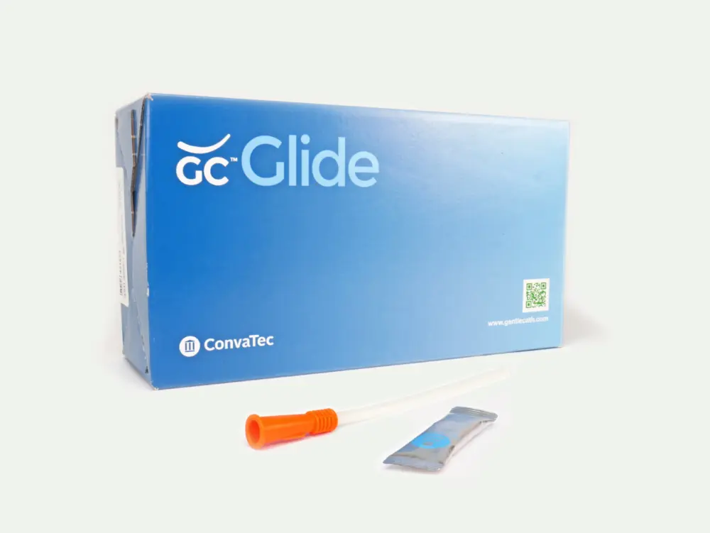 Picture of a box of 30 GentleCath Glide catheters from RA Fischer. In front of the box is one of the catheters with an orange gripper next to a packet of lubrication or water packet. Box reads "GC Glide" "Convatec" "www.gentlecath.com" and a QR Code