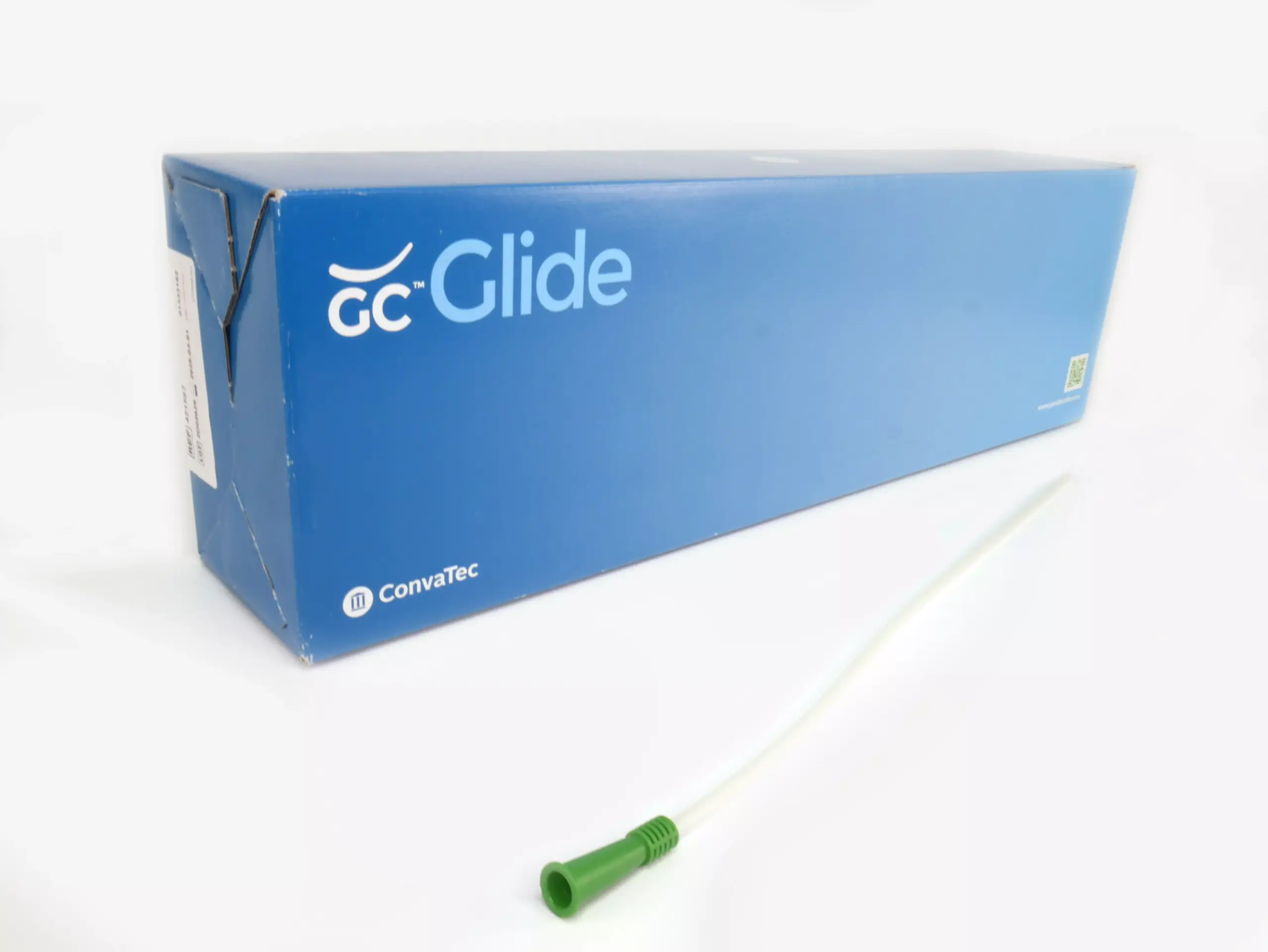 An image featuring a white background with a box of 30 GentleCath Glide catheters from RA Fischer. Positioned in front of the box is one of the catheters with an green gripper. The box prominently displays "GC Glide," "Convatec," "www.gentlecath.com," and includes a QR code.