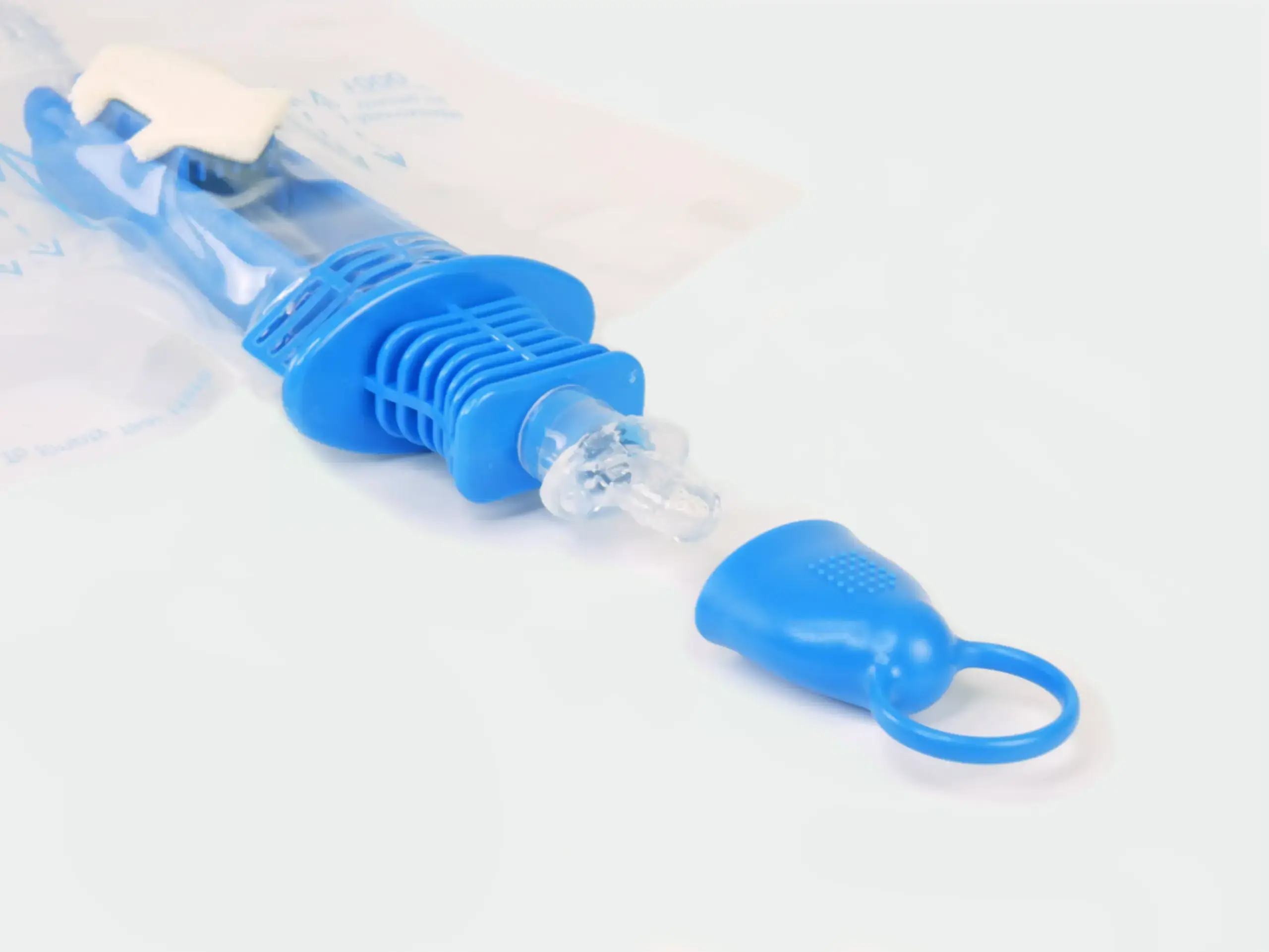 Close-up photograph of one of RA Fischer Co.'s Cure Catheters, closed system, blue [ Personalized urology care ]
