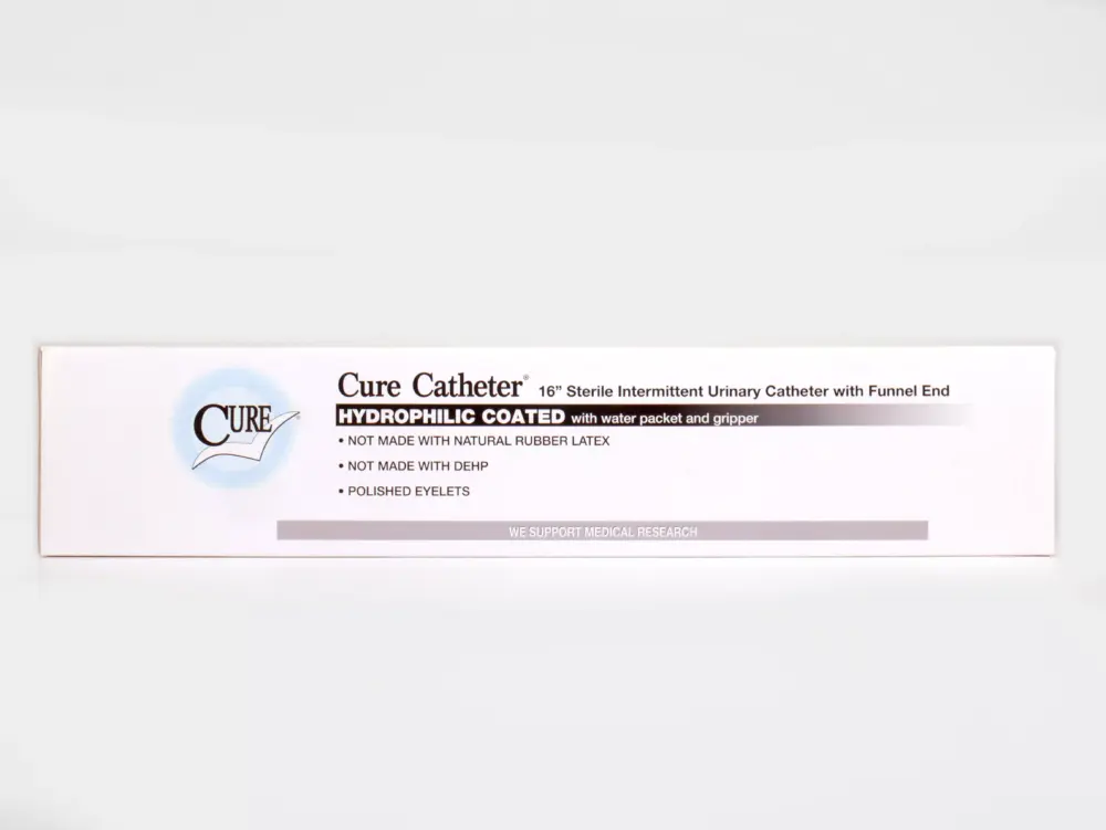 A box of Cure Catheters from RA Fischer Co. placed on a white surface. Box reads "Cure Catheter. 16" Sterile Intermittent Urinary Catheter with Funnel End. Hydrophilic coated with water packet and gripper. Not made with natural rubber latex. Not made with DEHP. Polished eyelets. We support medical research."