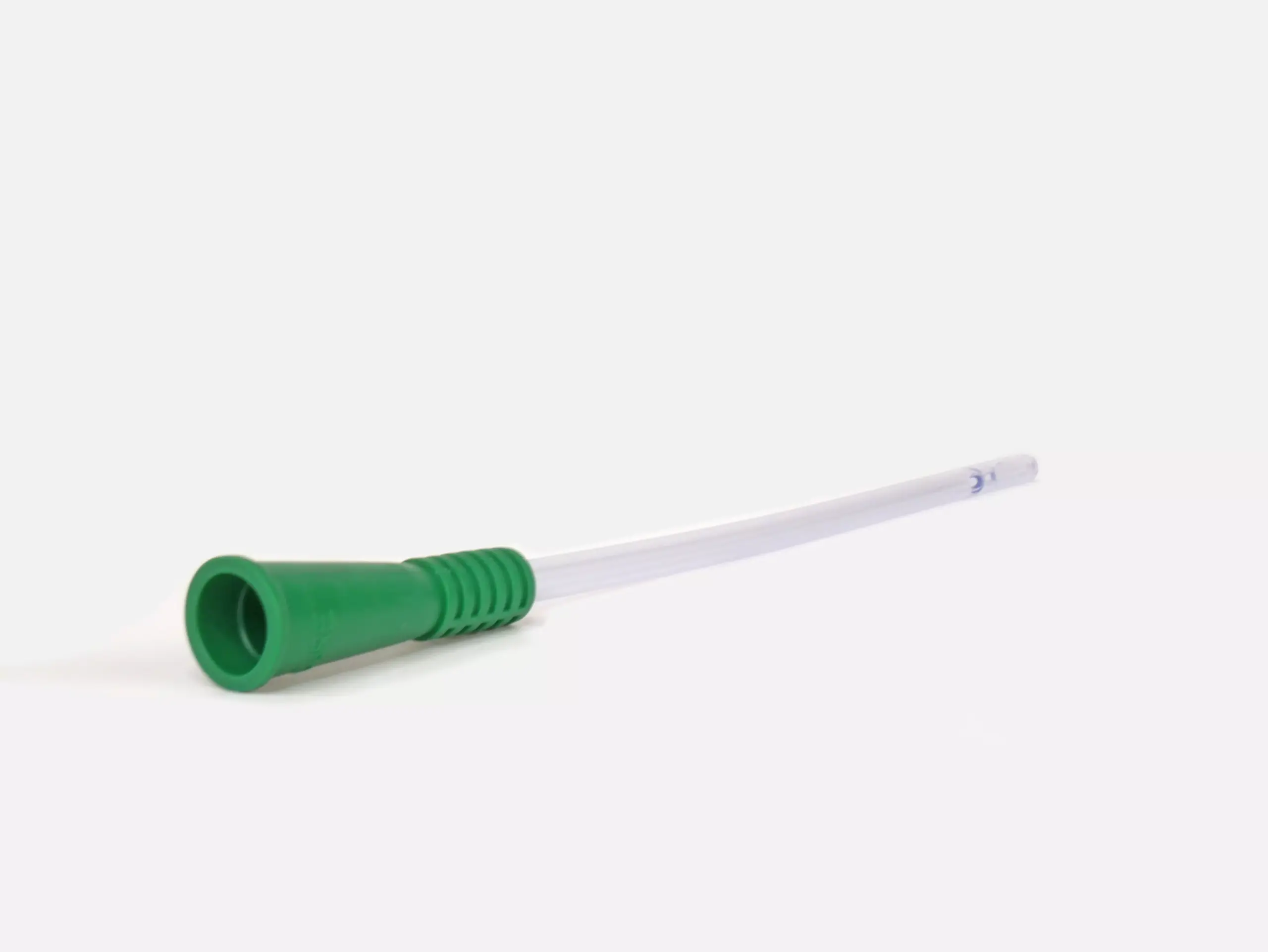 Close-up product image photograph of one of the RA Fischer Co.'s catheters available for urological care. Cure brand. Focus of the photograph is the green gripper sleeve on the end of the catheter