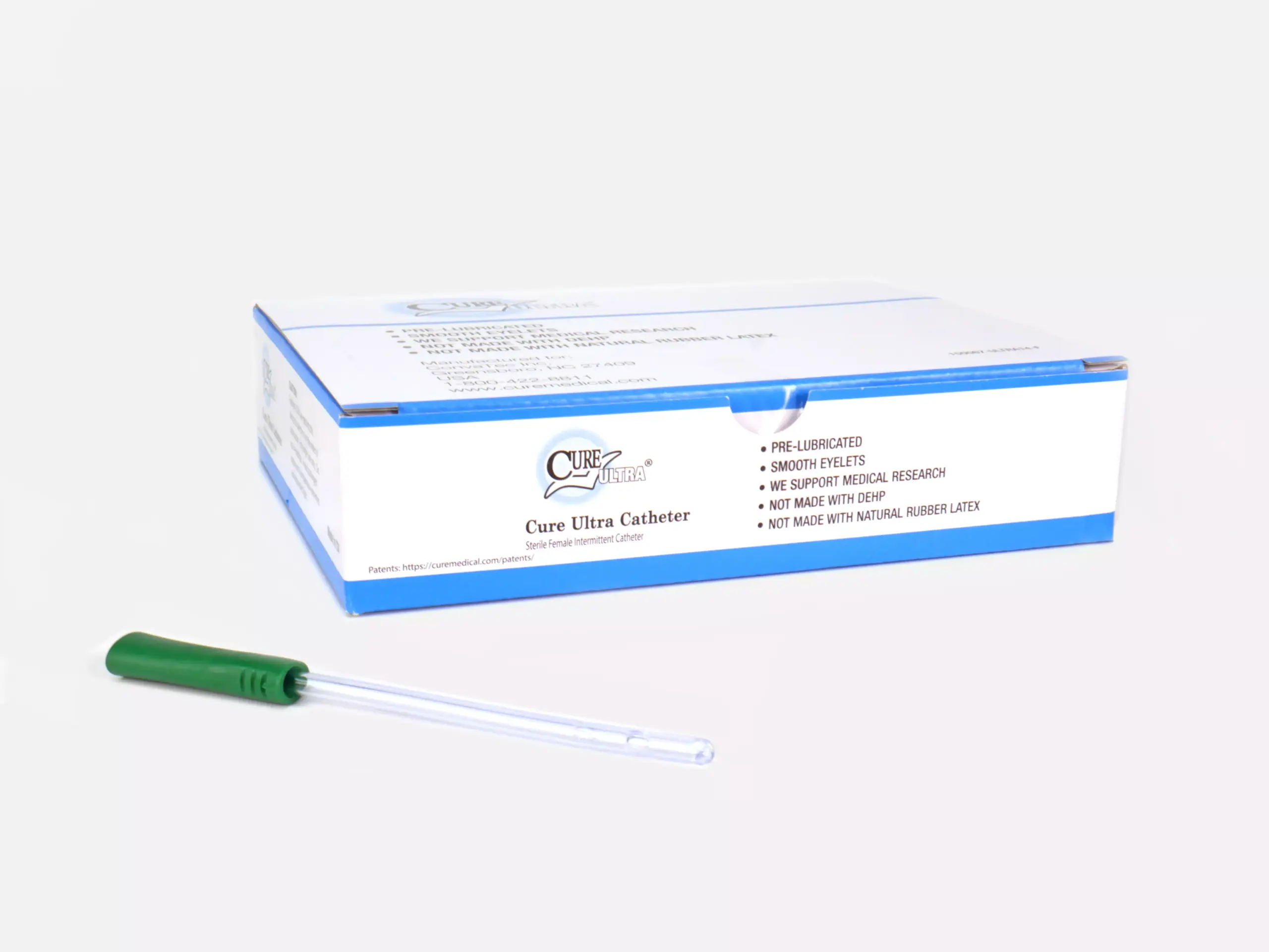Image featuring a box of Cure Ultra pre-lubricated catheters from RA Fischer. In front of the box is one of the catheters with a green grip. Box reads 'CURE ULTRA,' 'PRE-LUBRICATED,' 'SMOOTH EYELETS,' 'WE SUPPORT MEDICAL RESEARCH,' 'NOT MADE WITH DEHP,' 'NOT MADE WITH NATURAL RUBBER LATEX.'