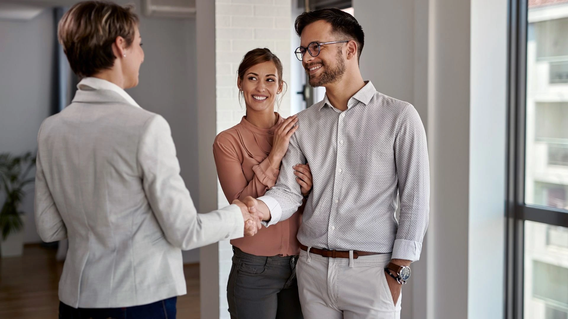 Picture of patients living a full life, shaking hands with a realtor.