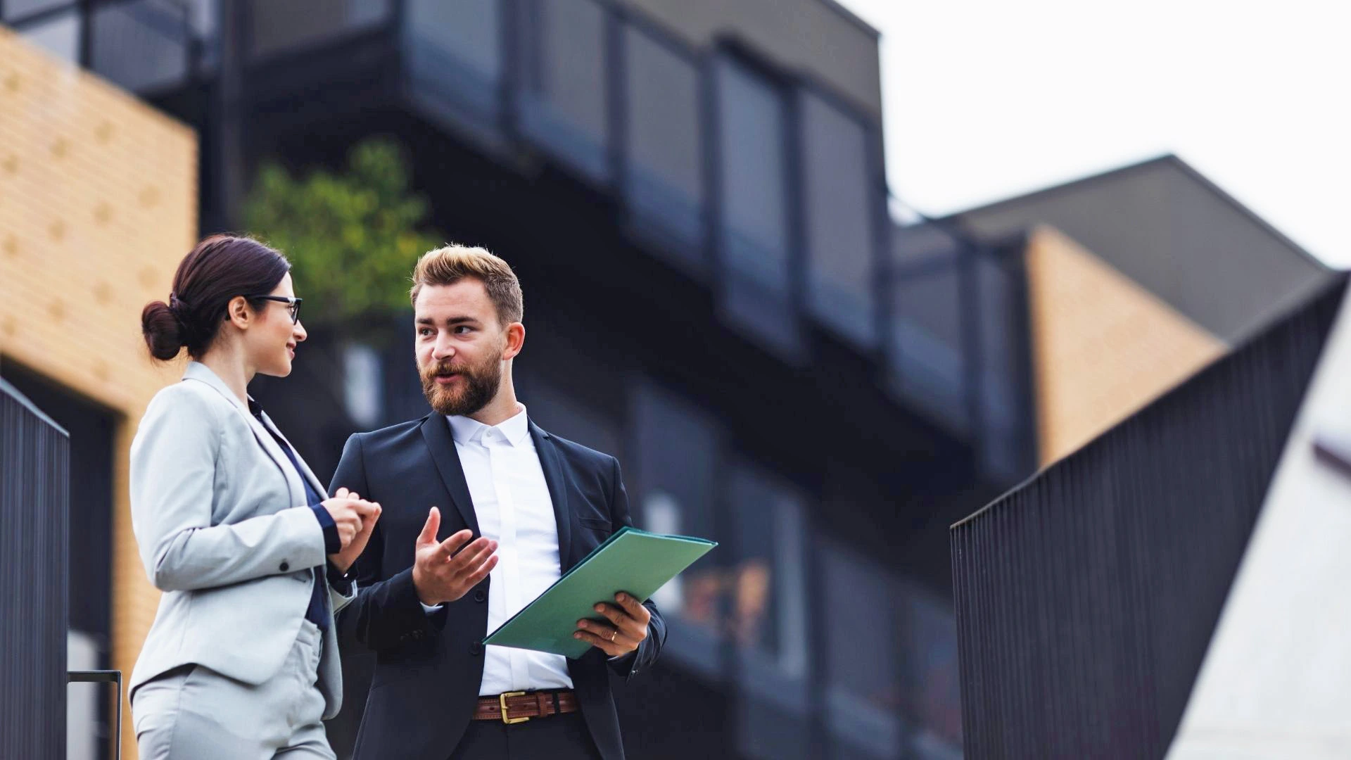 Picture of a patient discussing something with his significant other, holding a pad of paper, dressed professionally [insurance coverage for medical supplies] [ Personalized urology care ]