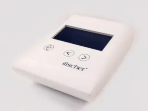Photograph of RA Fischer's 'The Fischer' Device, showcasing the white, rectangular 'main control unit.' This specialized iontophoresis device is meticulously designed for the treatment of hyperhidrosis (excessive sweating). The device features a grey screen, with buttons labeled 'SET' and directional arrows. In the bottom right corner, there's the logo of the Fischer device. Fischer sweat treatment iontophoresis