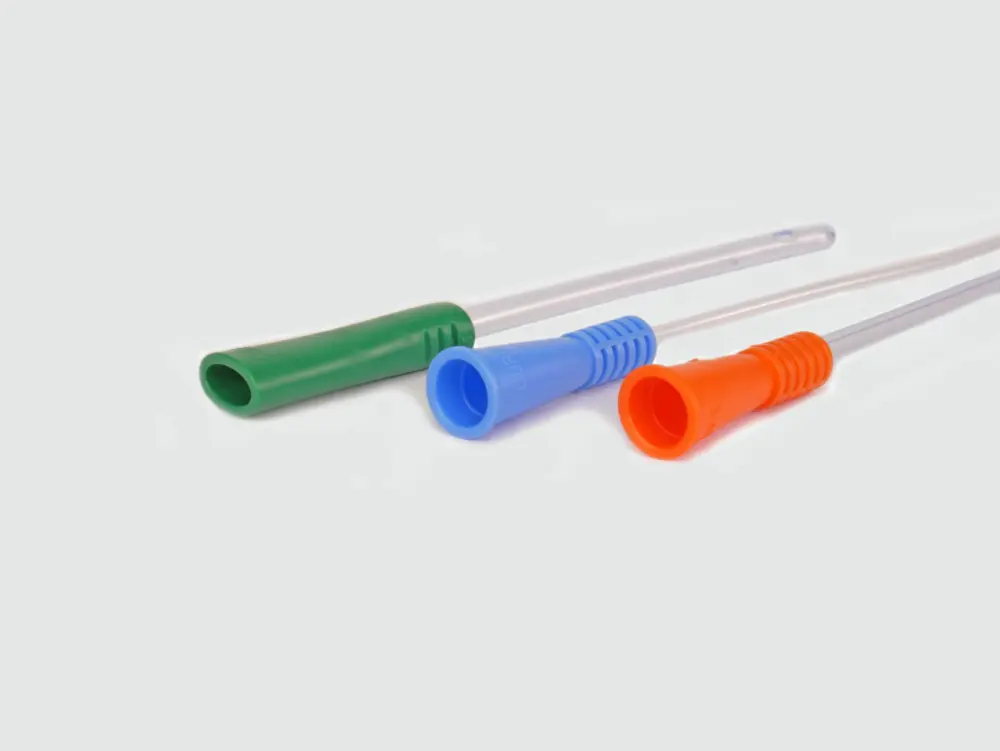 Photograph of an assortment of three RA Fischer Co. catheters of deferring lengths and gripper sleeve colors. The catheters are lined up on a flat surface. Gripper colors are blue green orange. White background