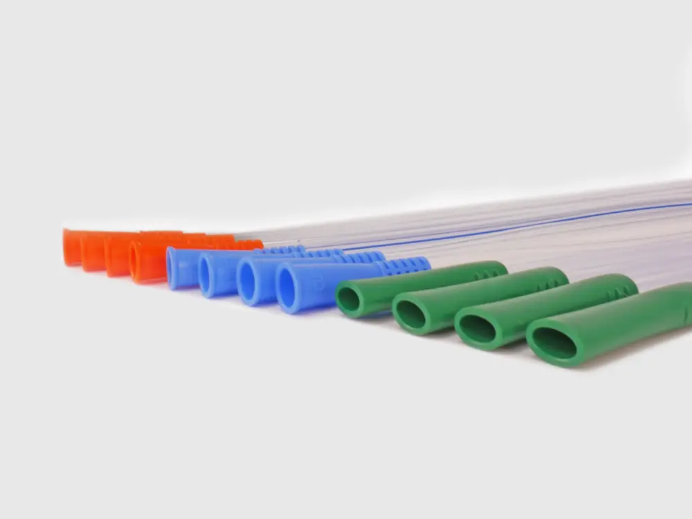 Photograph of an assortment of twelve RA Fischer Co. catheters of deferring lengths and gripper sleeve colors. The catheters are lined up and laying down on a flat surface. Gripper colors are blue green orange. White background