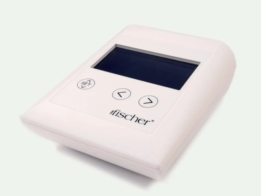 Picture of The Fischer's main control unit, close-up. Device is white and rectangular. Buttons read "SET" and arrows. Logo of the Fischer device bottom right corner [ Iontophoresis Device for Excessive Sweating ]