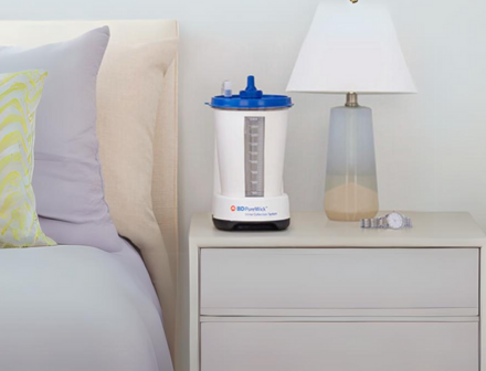 Picture of the Purewick urine collection system on a bedside table.