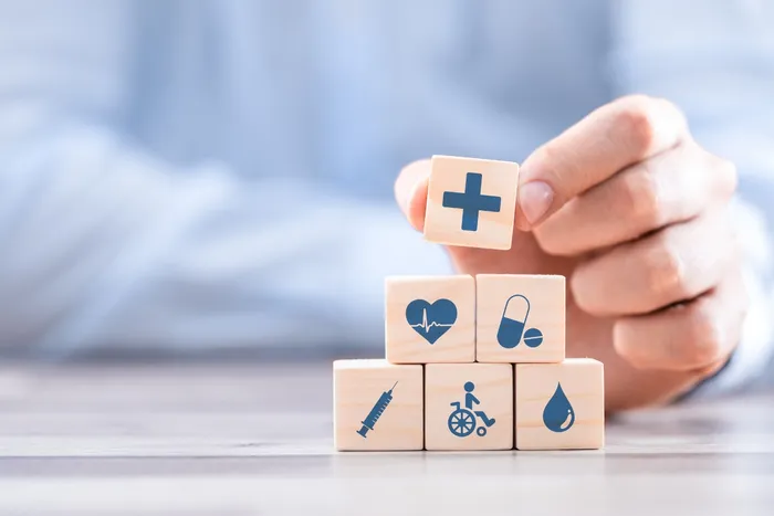 Image of a person who is holding wooden blocks with medical icons on them. Doctors Specializing in Hyperhidrosis.